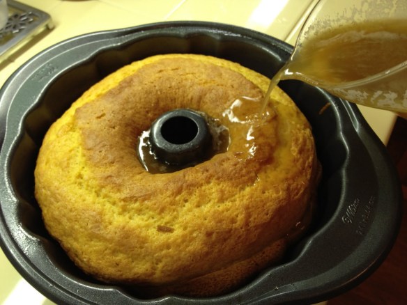 pouring glaze on rum cake