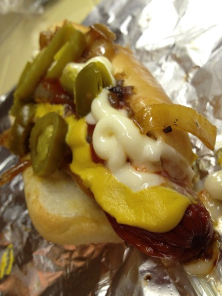 Bacon wrapped hot dog with everything